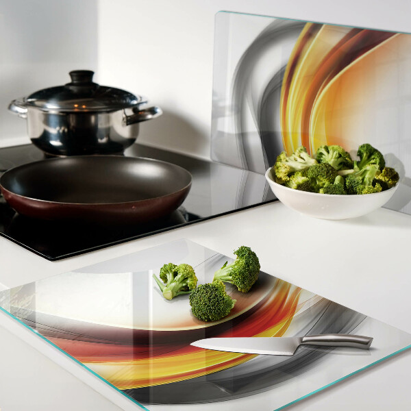 Glas-Schneidebrett mit Wellenmotiv in Orange und Schwarz