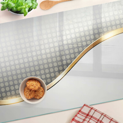 Schneidebrett glas Eine goldene Welle auf einem Hintergrund aus Punkten