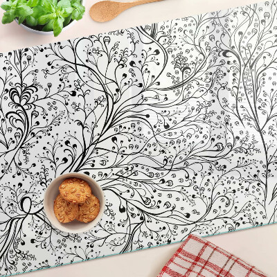 Glas Schneidebrett mit Pflanzenmuster und zarten Zweigen