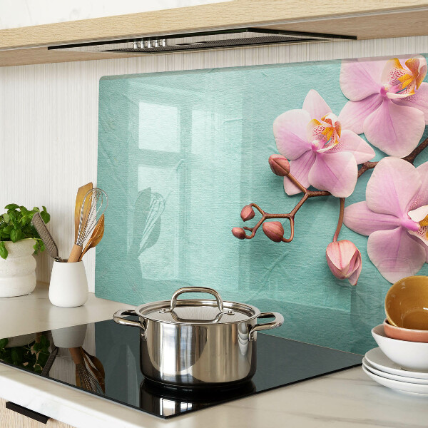 Glas Schneidebrett mit Orchideenmotiv auf blauem Hintergrund