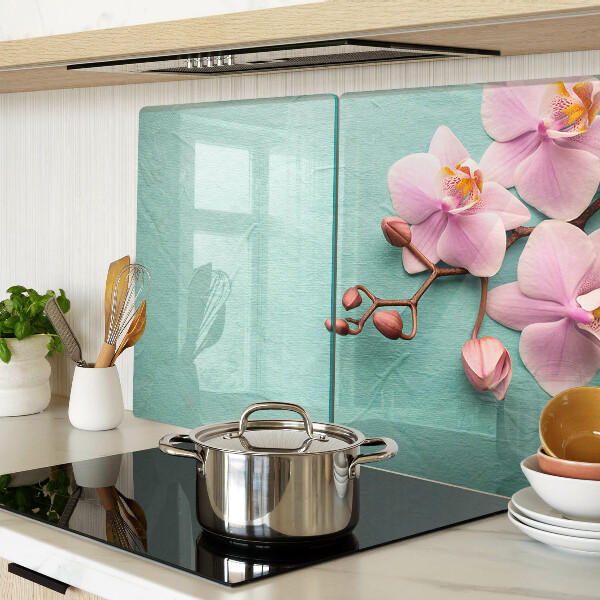 Glas Schneidebrett mit Orchideenmotiv auf blauem Hintergrund