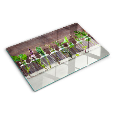 Glas-Schneidebrett mit dekorativem Motiv „Pflanzen in Flaschen”