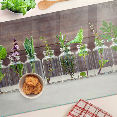 Glas-Schneidebrett mit dekorativem Motiv „Pflanzen in Flaschen”