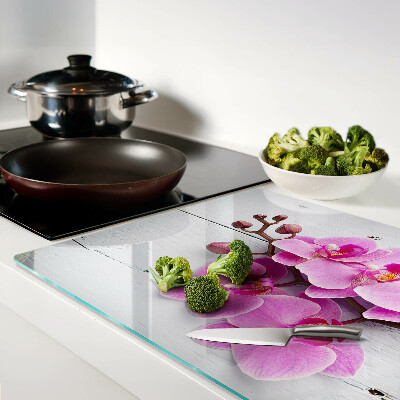 Schneidebrett Glas mit Orchideenmotiv auf weißem Hintergrund