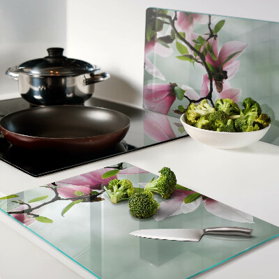 Schneidebrett Magnolienblüten vor grünem Hintergrund