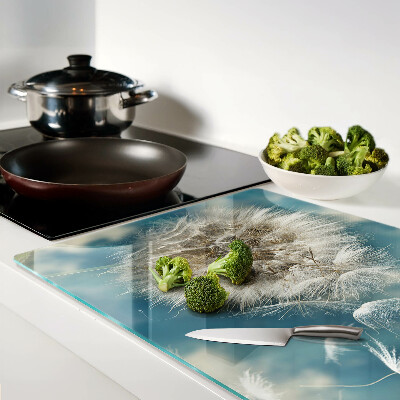 Glas schneidebrett Löwenzahn vor dem Himmel