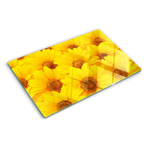Schneidebrett Glas mit Sonnenblumen vor gelbem Hintergrund