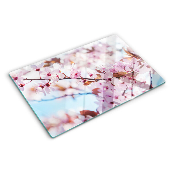 Schneidebrett Glas mit Kirschblüten auf blauem Hintergrund