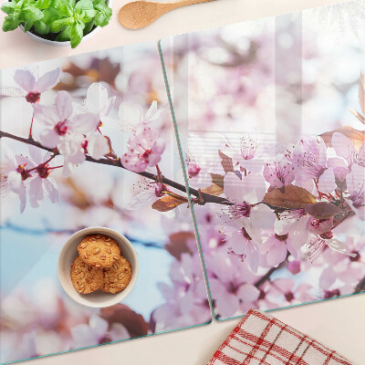 Schneidebrett Glas mit Kirschblüten auf blauem Hintergrund