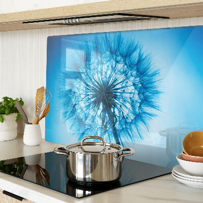 Glas-Schneidebrett mit Löwenzahn-Motiv auf blauem Hintergrund