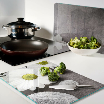 Schneidebrett glas Blumen und Steine ​​im Hintergrund