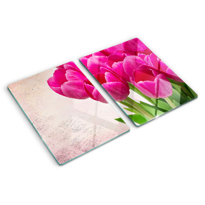 Schneidebrett Glas mit Tulpenblüten auf rosa Hintergrund