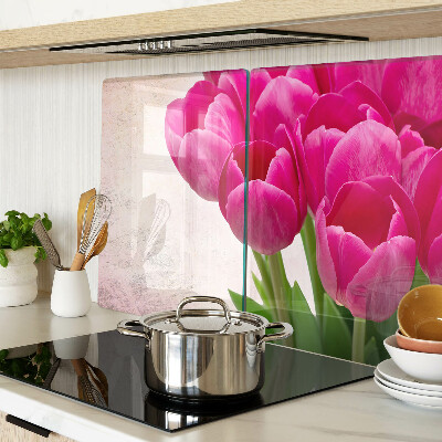 Schneidebrett Glas mit Tulpenblüten auf rosa Hintergrund