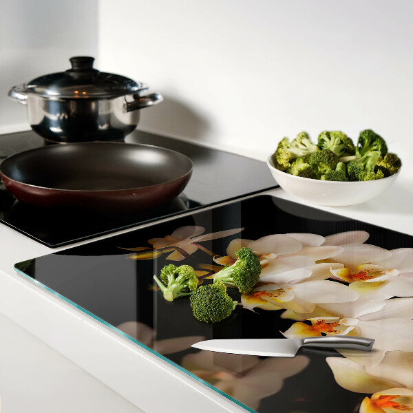 Glas Schneidebrett mit Orchideen-Motiv auf schwarzem Hintergrund