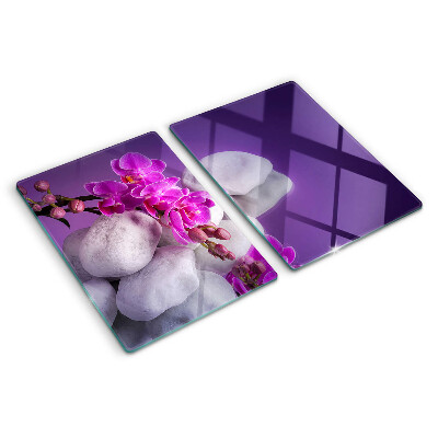 Schneidebrett Orchideenblüten vor einem steinernen Hintergrund