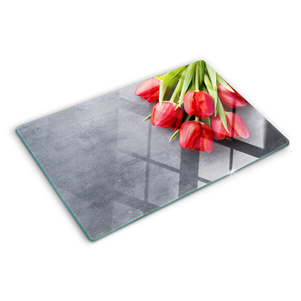 Glas schneidebrett Tulpen auf grauem Hintergrund