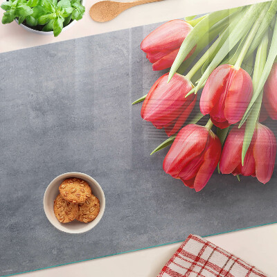 Glas-Schneidebrett mit Tulpenmotiv auf grauem Hintergrund