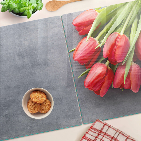 Glas-Schneidebrett mit Tulpenmotiv auf grauem Hintergrund