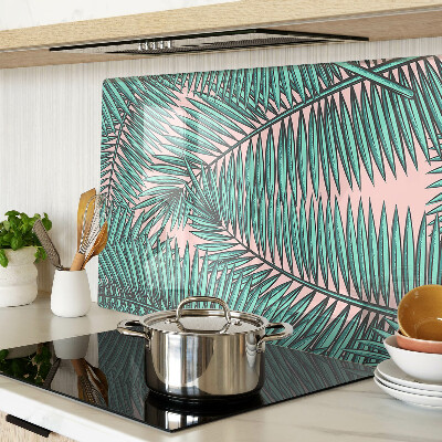 Glas schneidebrett Palmenblätter auf rosa Hintergrund