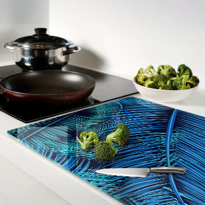 Glas-Schneidebrett mit Palmenblättern in Blautönen