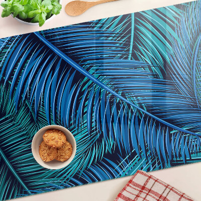 Glas-Schneidebrett mit Palmenblättern in Blautönen