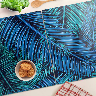 Glas-Schneidebrett mit Palmenblättern in Blautönen