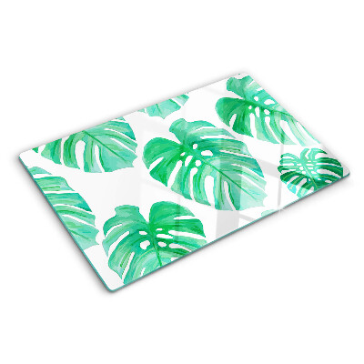 Glas schneidebrett Monstera-Blätter auf weißem Hintergrund