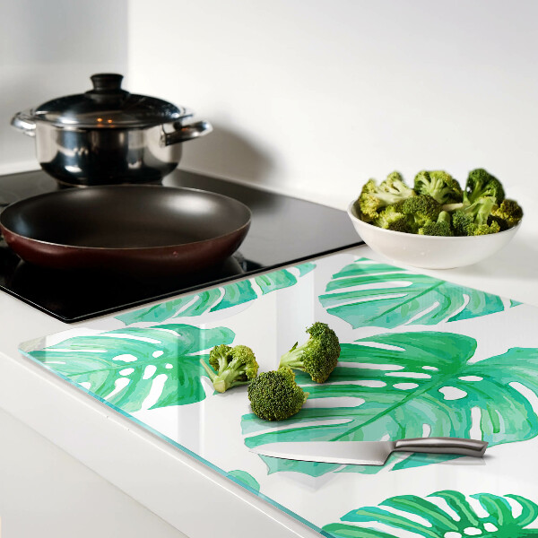 Glas schneidebrett Monstera-Blätter auf weißem Hintergrund