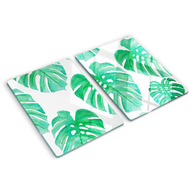 Glas schneidebrett Monstera-Blätter auf weißem Hintergrund