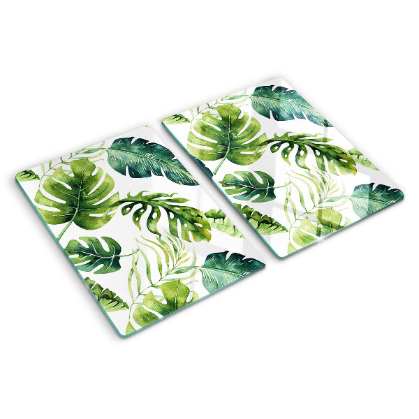 Schneidebrett mit Monstera‑Blättern in Grüntönen