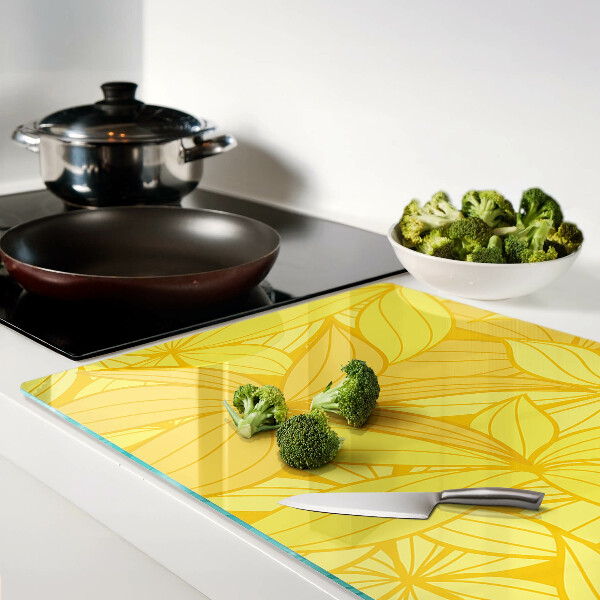 Glas-Schneidebrett mit gelbem tropischem Blattmotiv