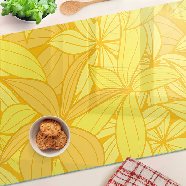 Glas-Schneidebrett mit gelbem tropischem Blattmotiv