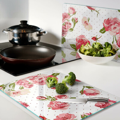 Glas-Schneidebrett mit Rosendekor auf weißem Hintergrund