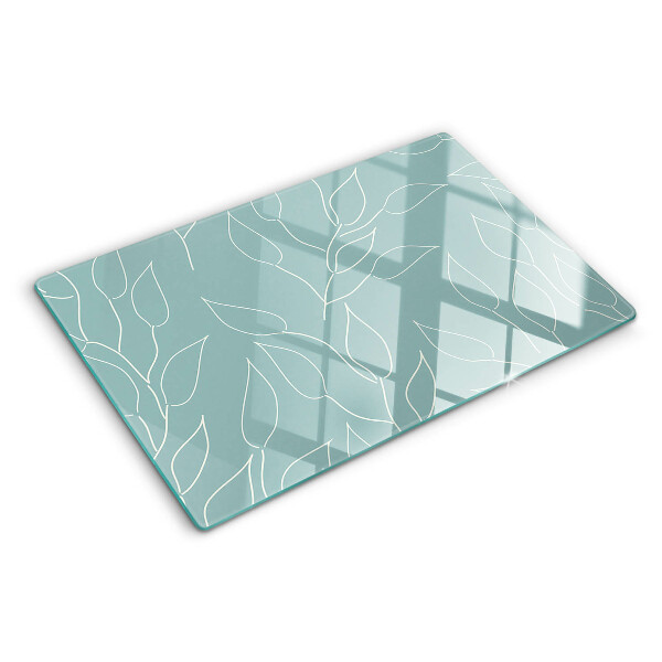 Schneidebrett Glas mit Motiv von Blättern im Hintergrund
