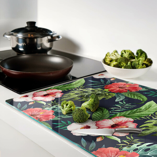 Glas-Schneidebrett mit tropischen Blumen und Blättern