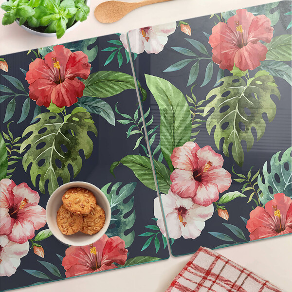 Glas-Schneidebrett mit tropischen Blumen und Blättern