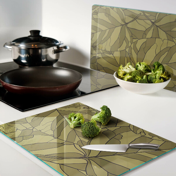 Schneidebrett mit Blattmotiv in Goldtönen