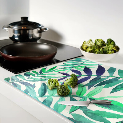 Glas-Schneidebrett mit Palmenblättern im Aquarellstil