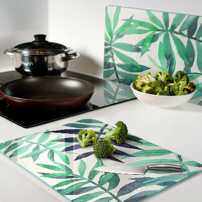 Glas-Schneidebrett mit Palmenblättern im Aquarellstil