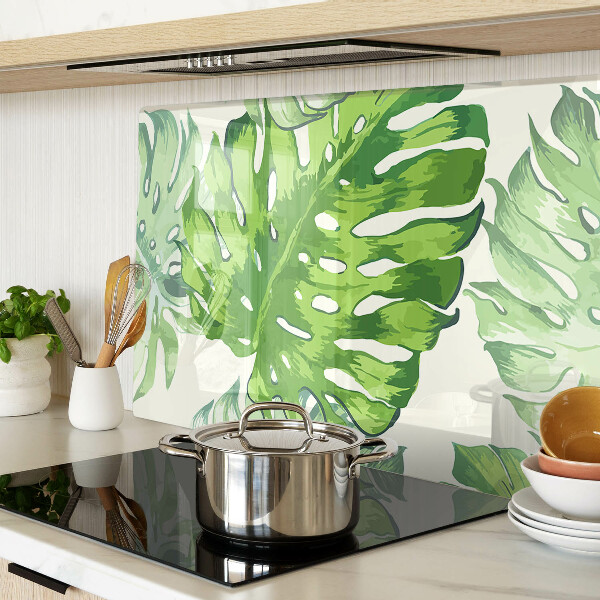 Schneidebrett mit Monstera-Blättern auf hellem Hintergrund