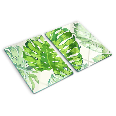 Schneidebrett mit Monstera-Blättern auf hellem Hintergrund