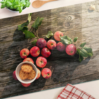 Glas-Schneidebrett mit Motiv von Äpfeln auf Holzgrund
