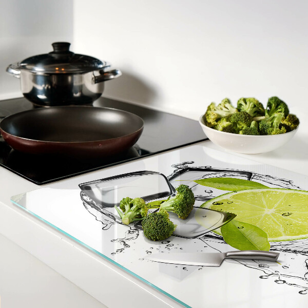 Glas-Schneidebrett mit Motiv einer Zitrone auf Eis und Blättern