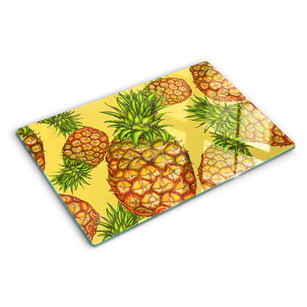 Schneidebrett mit Ananas-Motiv vor gelbem Hintergrund