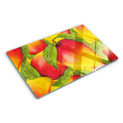 Glas-Schneidebrett mit Paprika vor grünem Blätterhintergrund