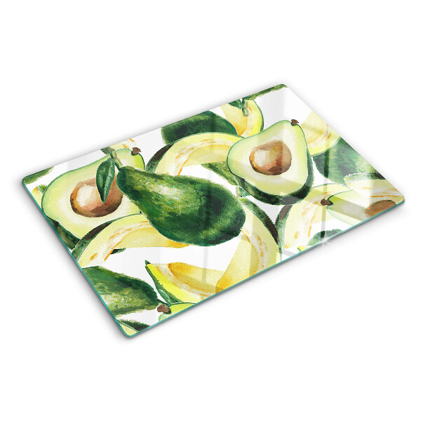 Glas-Schneidebrett mit Avocado-Motiv und Blättern im Hintergrund