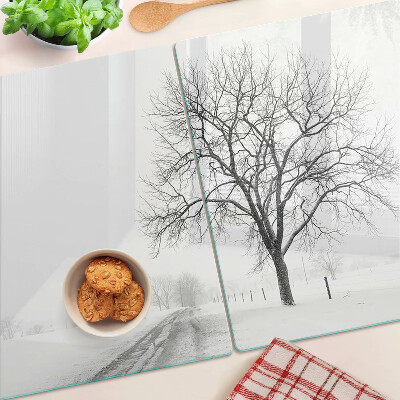 Schneidebrett mit Motiv einer winterlichen Landschaft und einem Baum