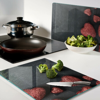 Schneidebrett Glas mit rotem Herzmuster auf dunklem Hintergrund