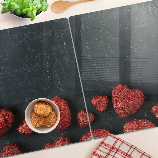 Schneidebrett Glas mit rotem Herzmuster auf dunklem Hintergrund