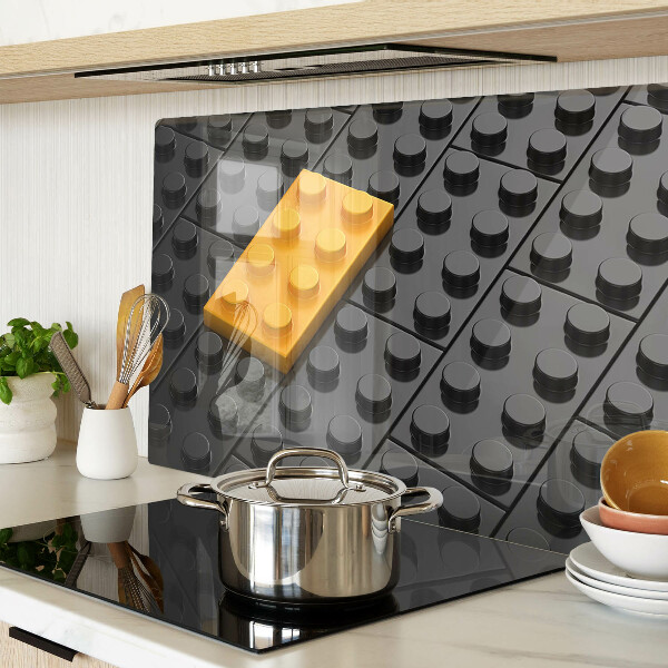 Glas-Schneidebrett mit Motiv aus LEGO-Steinen auf schwarzem Hintergrund